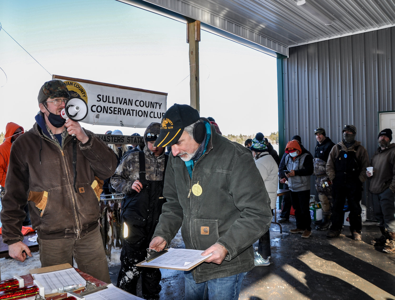 Sullivan County Conservation Club President John Van Etten, left, and secretary Jay Mendels tallying the list of winners in both adult and youth divisions, where thousands of dollars in prizes were awarded last weekend in Bethel, NY.